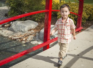 Young chinese and caucasian boy having fun at the park