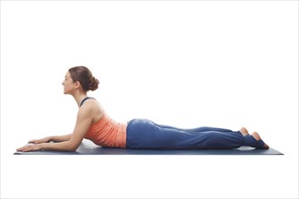 Beautiful sporty fit yogini woman practices yoga asana salamba bhujangasana, sphinx pose beginnner