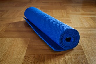 Yoga mat on wooden floor