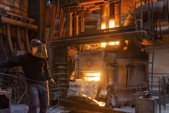 The Schmees foundry in Pirna, Germany, taking a sample of the molten metal, Europe