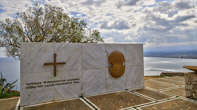 HDR, war memorial to Greek cadets of WW2, marble slab, cloudy dramatic sky, east coast of Rodopou