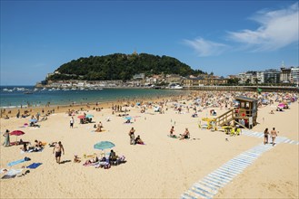 Crowded beach with people in August, San Sebastian, Donostia, Basque Country, Northern Spain,