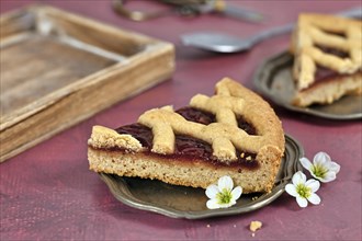 Single slice of pie called 'Linzer Torte', a traditional Austrian shortcake pastry topped with