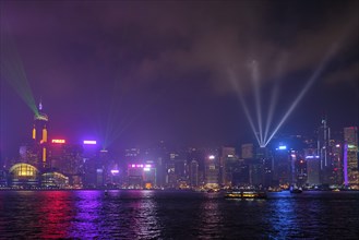 Hong Kong skyline cityscape downtown skyscrapers over Victoria Harbour in the evening illuminated