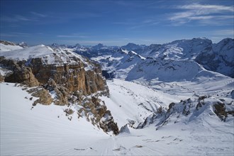 View of a ski resort piste and Dolomites mountains in Italy from Passo Pordoi pass. Arabba, Italy,