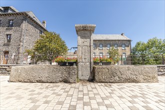 Old fountain with fresh water on square in village Aubrac. Aveyron, France, Europe