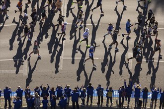 Marathon runners and their shadows at the 50th BMW Berlin Marathon 2024 on 29 September 2024