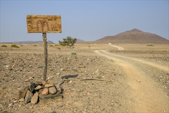 Homemade sign Mc Doland's Drive in the middle of the desert, near Sanitatis, Khumib dry river,