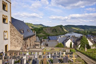 Cemetery with St Laurentius Church and Moselle in Bremm, district of Cochem-Zell,