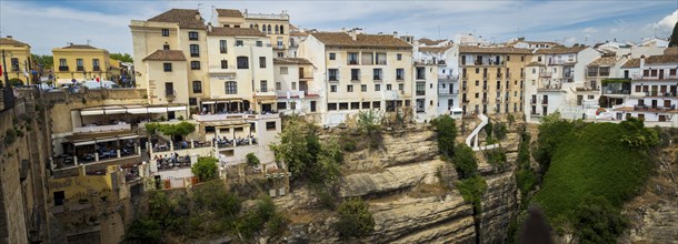 Ronda, Spain, April 2023: View on the restaurants and houses built on the cliffs on Puerte Nuevo in