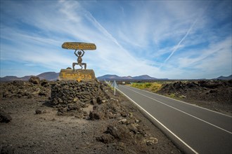 Timanfaya, Lanzarote, Spain, March 2023: View on the entrance sign and road of Timanfaya National