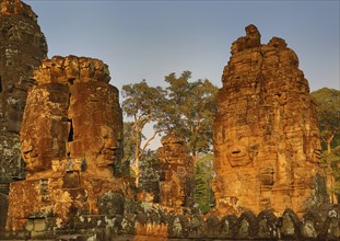 Giant stone faces at Bayon Temple at sunset, Angkor Wat, Cambodia, Asia