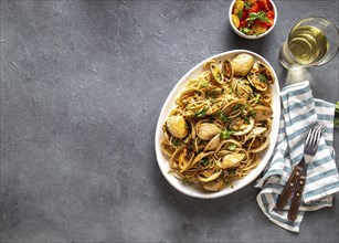 Seafood Pasta. ITALIAN SPAGHETTI ALLE VONGOLE. Clams spaghetti on white plate with white wine, gray