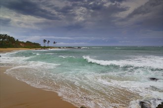 Beautiful sea stormy landscape over rocky beach in Indian ocean