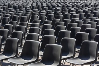 Rows of an empty black plastic seats