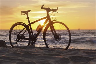 Black bike by the sea, bike and sunset by the sea