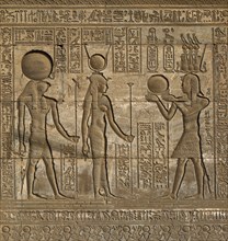 Hieroglyphic carvings on the exterior walls of an ancient egyptian temple