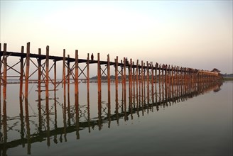 Famous U-Bein teak bridge at sunset on Taungthaman lake in Amarapura, Mandalay division, Myanmar,