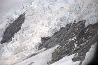 Franz Josef Glacier, Westland, New Zealand. Brown discolouration on the snow is smoke from