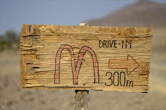 Homemade sign Mc Doland's Drive in the middle of the desert, near Sanitatis, Khumib dry river,