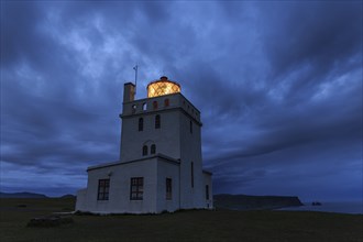 Lighthouse at the coast, twilight, cloudy mood, Dyrholaey, Iceland, Europe