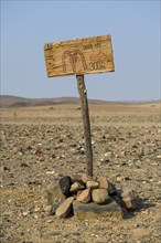 Homemade sign Mc Doland's Drive in the middle of the desert, near Sanitatis, Khumib dry river,