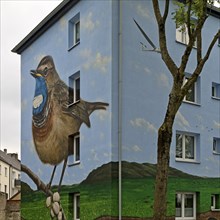 Residential buildings with a bluethroat as a mural after renovation, Bochum-Hamme, Ruhr area, North