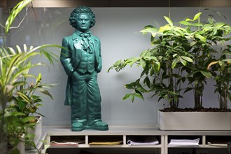 Green Beethoven figure in the office amidst room palaces at the information desk in the town hall,