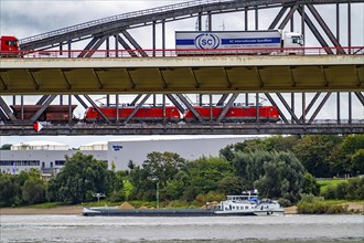 The Beeckerwerth Rhine bridge of the A42 motorway, truck traffic, in front of it the Haus-Knipp