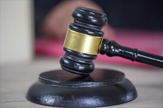 Symbolic image of a court hearing: close-up of a judge's gavel