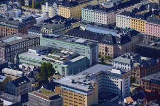 Aerial view of a city with densely packed buildings in different colours and styles, urban