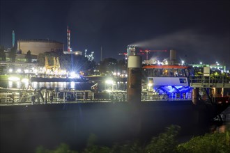 Night shot of BASF in Ludwigshafen with the Rhine in the foreground