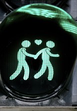 Green pedestrian traffic light with two men and heart, male traffic light couple, homosexual love,