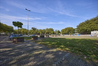 Large car park in the city centre of under a blue sky with cirrostratus clouds in Bocholt,