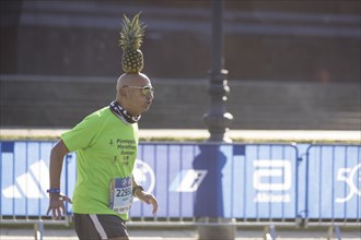 Pineapple Marathon Runner (Moshe Lederfein) balances a pineapple on his head during the run at the