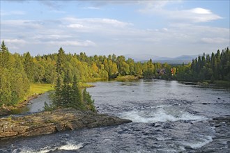 A river flows between rocks and trees while the sky is covered with clouds, Störlien, Jämtland,