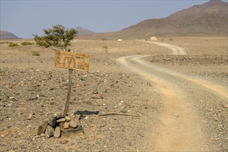 Homemade sign Mc Doland's Drive in the middle of the desert, near Sanitatis, Khumib dry river,