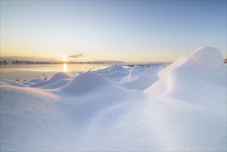 Winter snow cover with hills and a lake at sunrise, frosty atmosphere, Seegarten, Allensbach, Lake