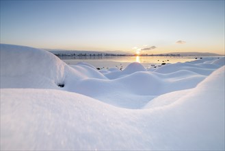 Winter snowy landscape on the lake at sunrise, quiet and peaceful atmosphere, Seegarten,