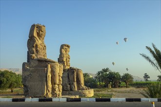 Colossi of Memnon gigantic statues and air balloons in Luxor Egypt