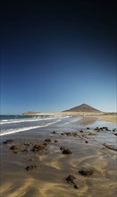 El medano tourist beach and montana roja famous landscape in tenerife spain