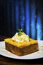 Exotic tropical fusion french toast dessert with mango and whipped cream