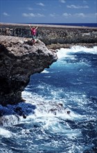 Woman watching surf on the coast, Netherlands Antilles, Bonaire, Caribbean, Caribbean Sea,