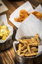 Rustic french fries and other simple snack food on table