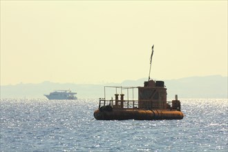 Abandoned rusty ship at anchor in Red sea