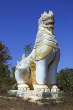 Ancient statue of lion guardian in Shwe Inn Thein Paya temple complex near Inle Lake in central