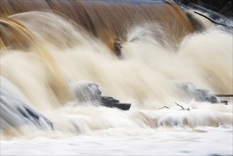 Waterfall, foaming and splashing waves of a river