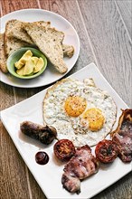 Traditional classic english british fried breakfast with eggs bacon tomato sausage and toast set