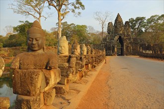 Stone carved statues of Devas on the bridge to Angkor Thom, Siem Reap, Cambodia, Asia