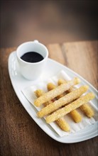 Churros and chocolate spanish donuts pastry doughnuts with sauce breakfast snack